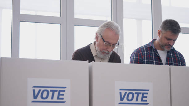 istock Two men making their choice, voting at a polling station on election day, responsibility 2165533375