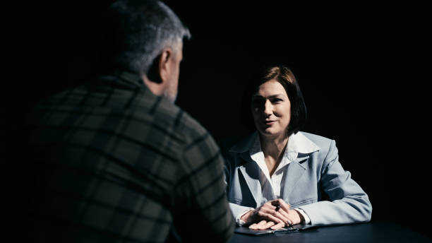 istock Arrested man visited by his lawyer, client conferring with attorney in private 2165533394