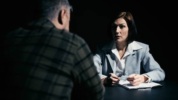 istock Female detective questioning a man in custody about a substance found during his arrest 2165533454