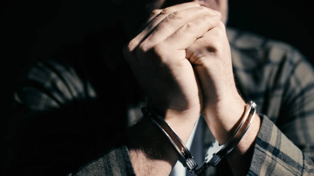 istock Scared man in handcuffs interrogated by police, investigation, interrogation 2165533456