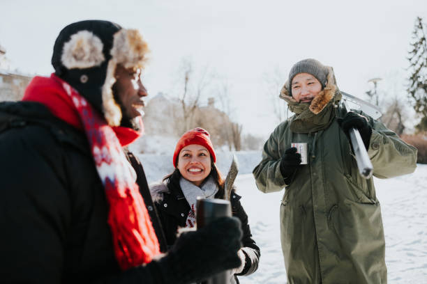 Friends drinking tea and having a chat outdoors at winter