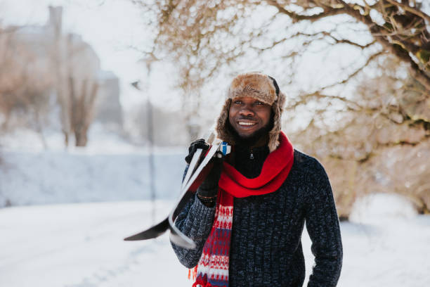 Smiling African man going skiing on a sunny day
