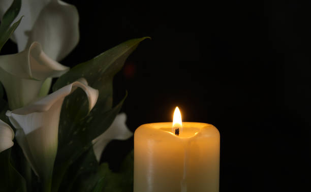istock Burning wax candle in close up and white calla lily 2165538626