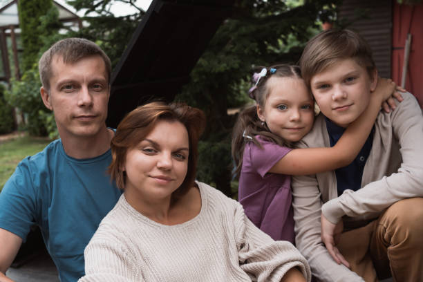 istock family poses for picture together while sitting in backyard 2165539736