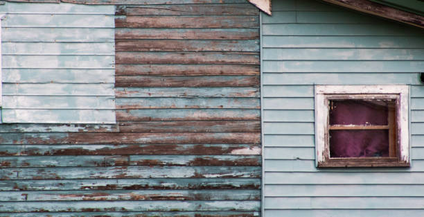 istock Side of a rustic old farmhouse with small window. 2165540185