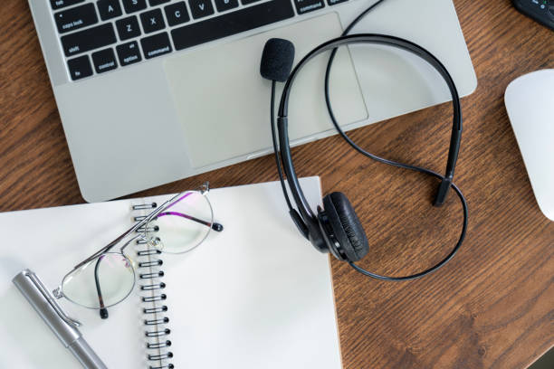 istock A work desk with headphones placed on it 2165540392