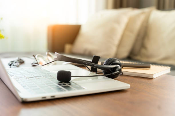 istock A work desk with headphones placed on it 2165540396