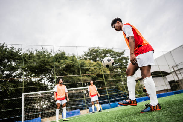 Soccer player making tricks with the ball on soccer field