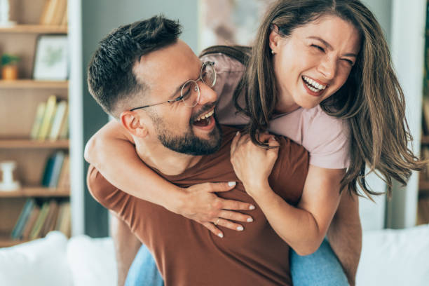 istock Young happy couple piggybacking at home 2165543576