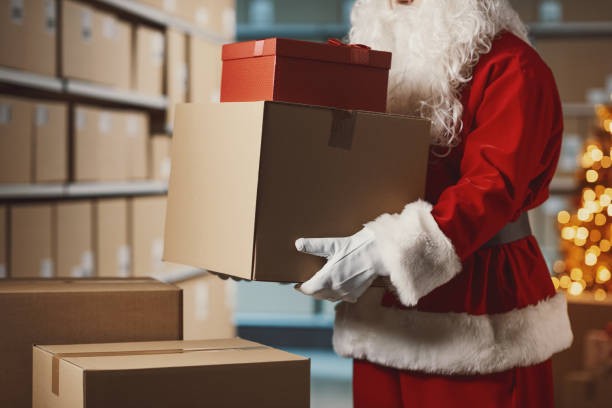 istock Santa Claus holding delivery boxes in the warehouse 2165545470