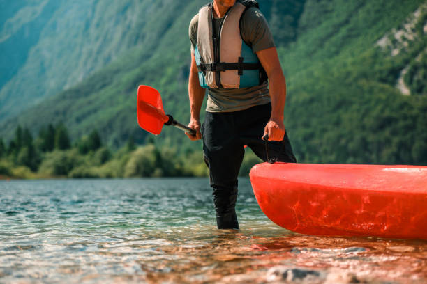 istock Man Preparing to Kayak on a Mountain Lake 2165545597