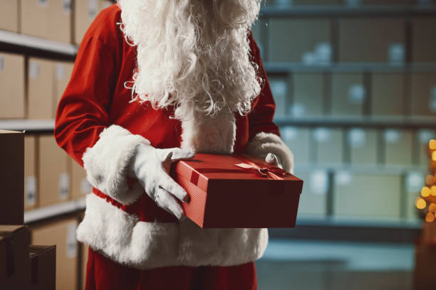 istock Santa Claus holding a gift box at the distribution warehouse 2165545607