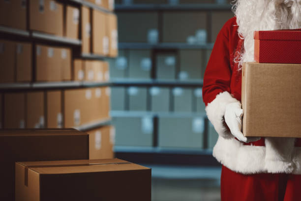 istock Santa Claus holding delivery boxes in the warehouse 2165546148