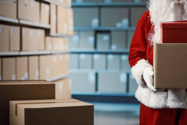 istock Santa Claus holding delivery boxes in the warehouse 2165546151