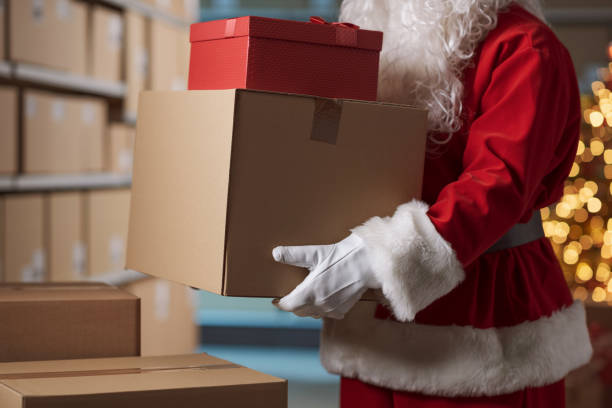 istock Santa Claus holding delivery boxes in the warehouse 2165546166