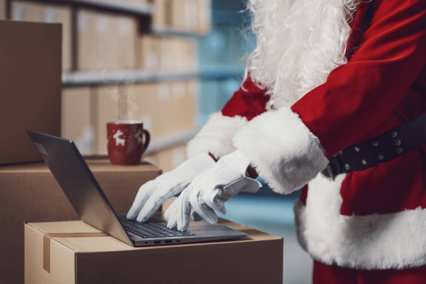 istock Santa Claus working with a laptop at the warehouse 2165546191