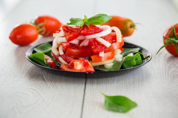 salad of fresh red tomatoes with onions.