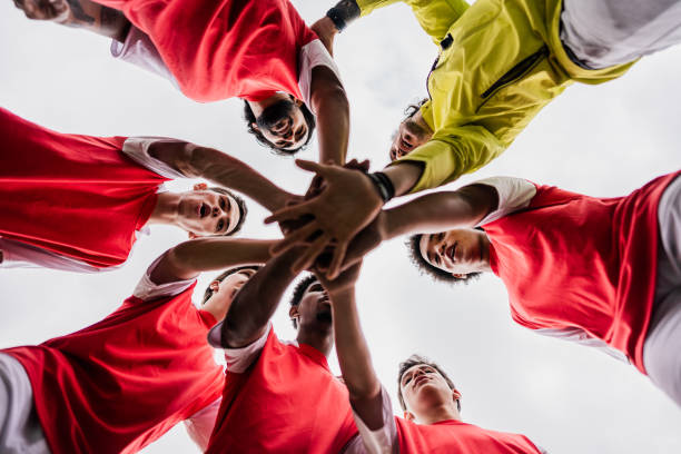 Soccer team stacking hands in the soccer field