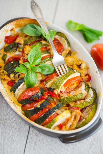 istock prepared baked zucchini and tomatoes in circles in a ceramic form, vegetable snack 2165547589