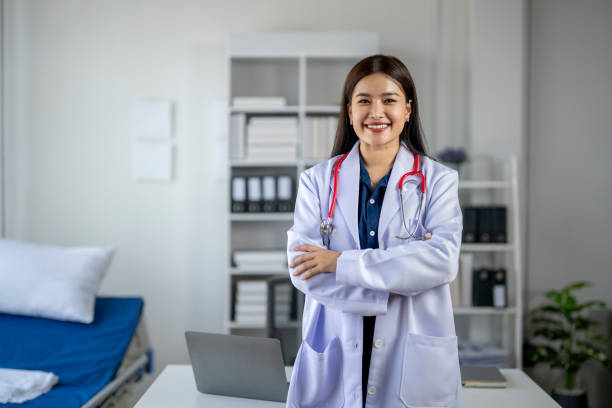 istock A woman in a white lab coat is smiling 2165548808