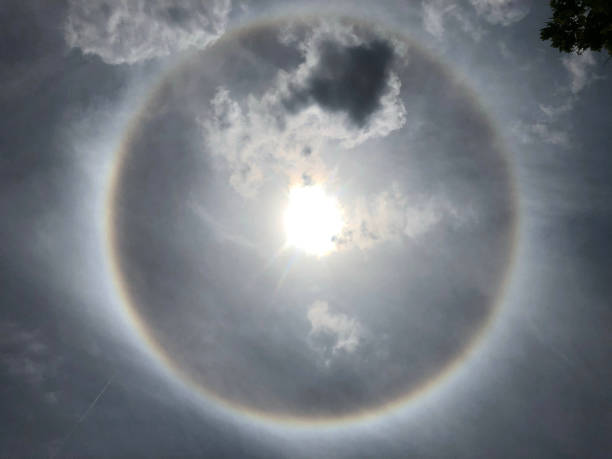 istock Spectacular Solar Halo - Rare Atmospheric Optical Phenomenon Caused by Sunlight Refracting Through Ice Crystals in Cloudy Sky. 2165549045