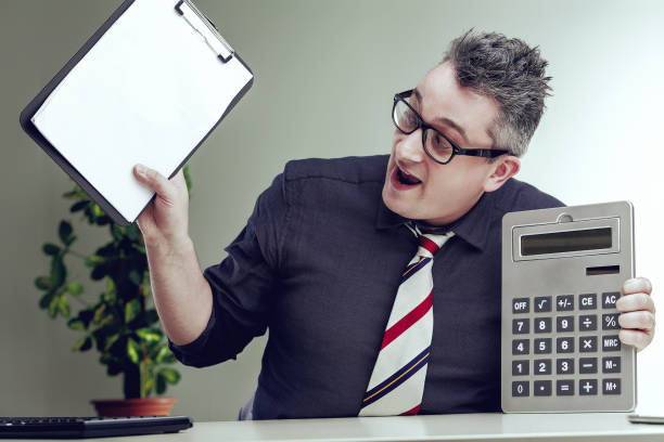 istock Accountant celebrating with calculator and clipboard at workplac 2165549969
