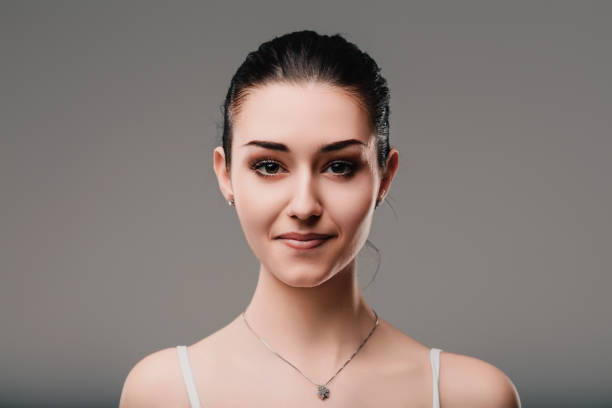 istock Young woman posing and showing her emotions on a grey background 2165550056