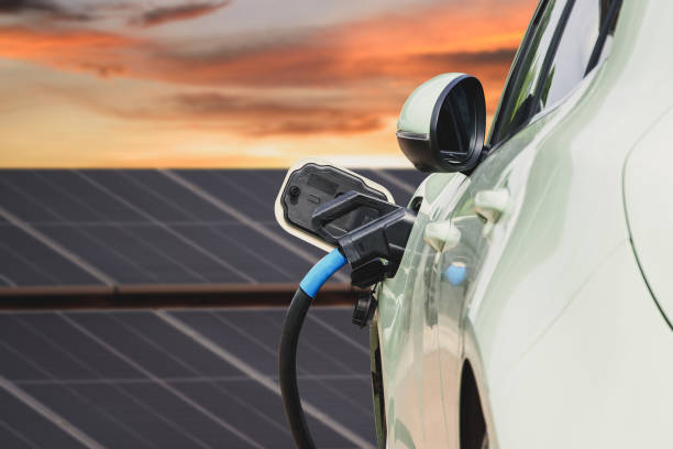 istock Charger car station, solar panel background. Sustainability assessment, renewable energy concept. Electric vehicle using sustainable. Saving, climate change. 2165555306