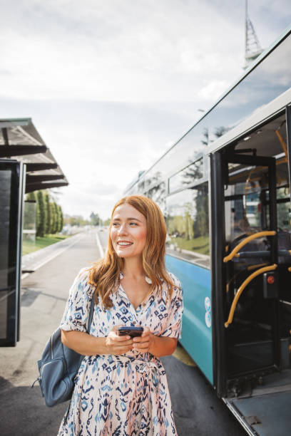 istock Waiting for bus and online investing 2165560163