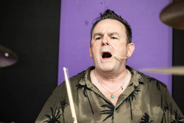 Part of a series - Mature aged male punk rock band in rehearsal: Drumming