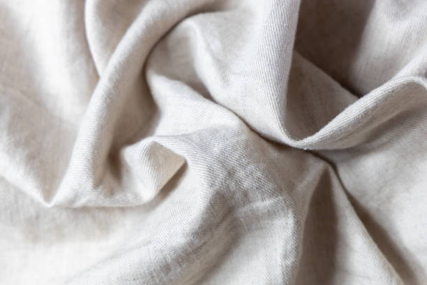 Textile background soft and crumpled light beige linen