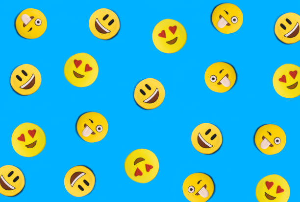 istock Smileys in the form of gingerbread on the blue background. Flat lay. Pattern. 2165564676