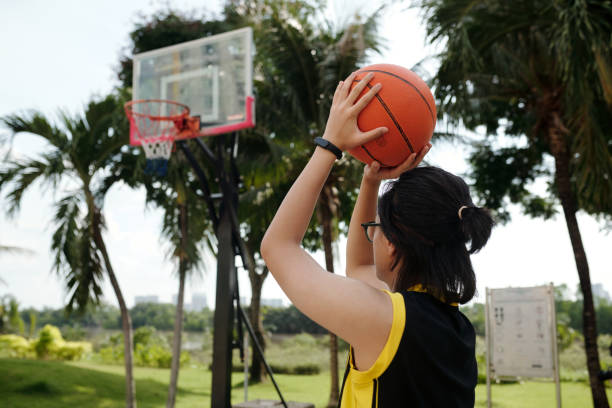 istock Playing Basketball Outdoors in Tropical Setting 2165564693