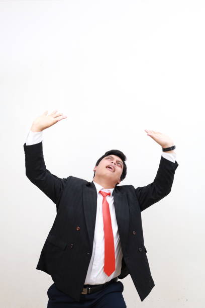 istock Asian Businessman pushing away virtual obstacles above him 2165564896