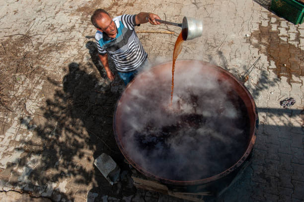 20.01.2024A villager making molasses from grapes in Gaziantep. boiling molasses in the cauldron