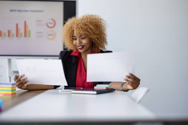 istock Woman comparing reports at an office meeting. 2165570449