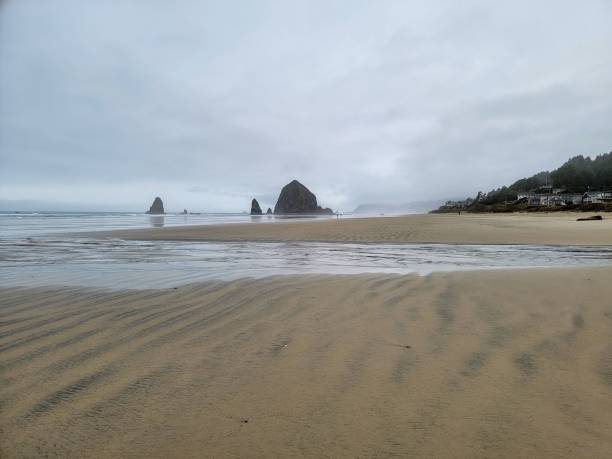istock Scenic view of Cannon Beach with Haystack Rock and cloudy sky in Oregon 2165571393