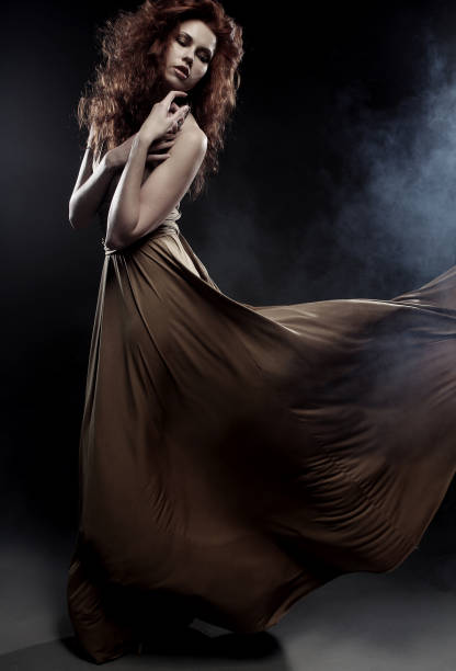 istock woman in long dress 2165574584