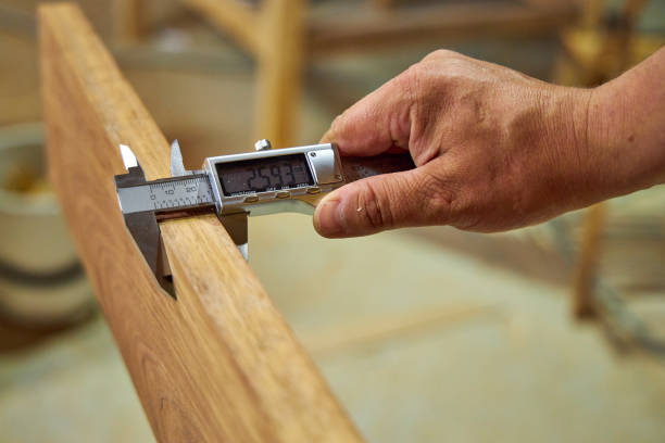 istock a man in a home carpentry workshop measures boards with a caliper close-up of hands 2165574838