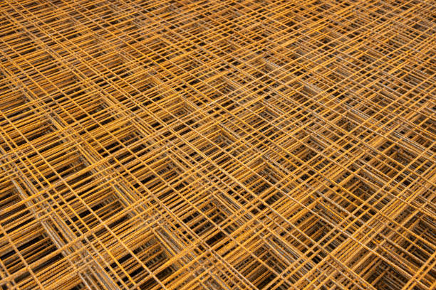 Iron wire welded mesh is a building material used for reinforcing concrete on construction sites. Full-frame view shows the mesh in detail.