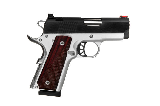 istock A small silver pistol with a wooden handle. Short-barreled weapon. Modern semi-automatic pistol isolate on a white background. 2165580633