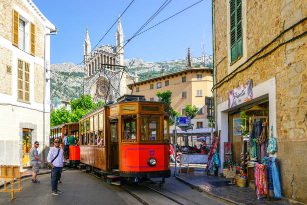 Soller, Spain- May 24, 2024: a vintage tram is passing through historical centre of Soller, Mallorca