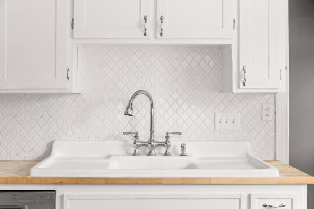 istock A kitchen sink detail with an arabesque tile backsplash. 2165583330