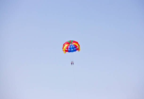 Parasailing on Aegean sea, town of Kuşadası in Turkey on a sunny summer day, View Of Kusadasi Skyline At Aegean Coast, Turkey.
