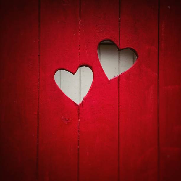 istock Cut out hearts in red panelling 2165594553