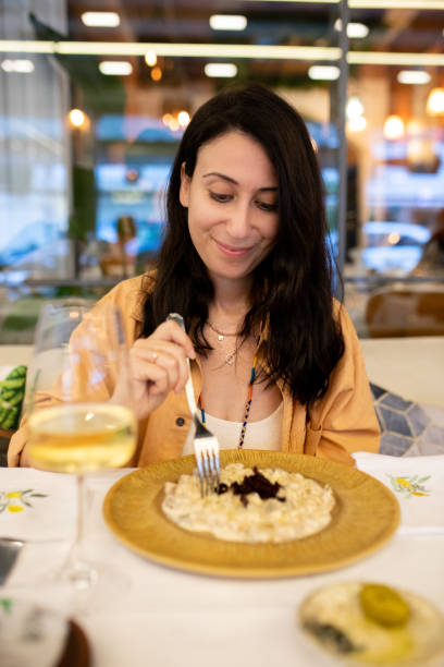 istock Woman drinking wine with eating gnocchi at dinner 2165594797