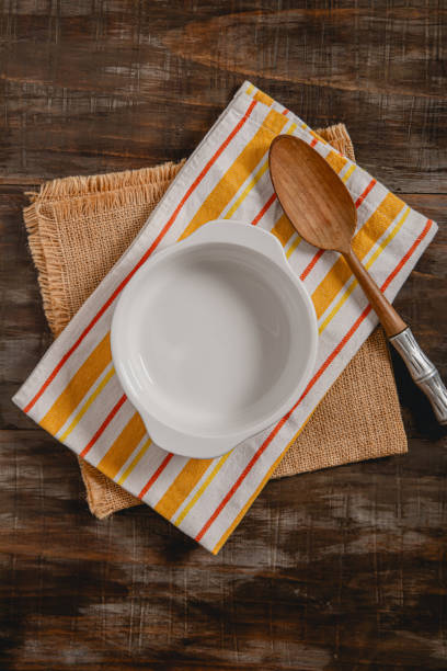 istock empty white bowl mock up on striped kitchen cloth with rustic wooden spoon with space for text 2165595358