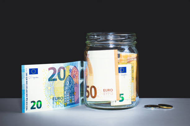 istock Euro banknotes stacked in a jar. 2165595436