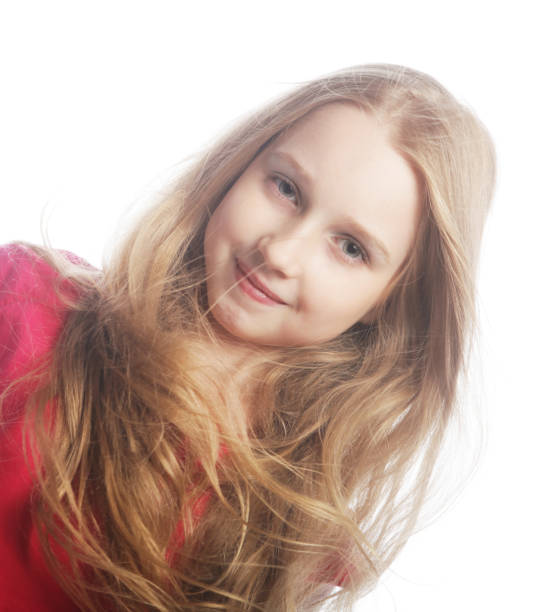 Candid portrait of cute little girl with messy long blonde wet hair