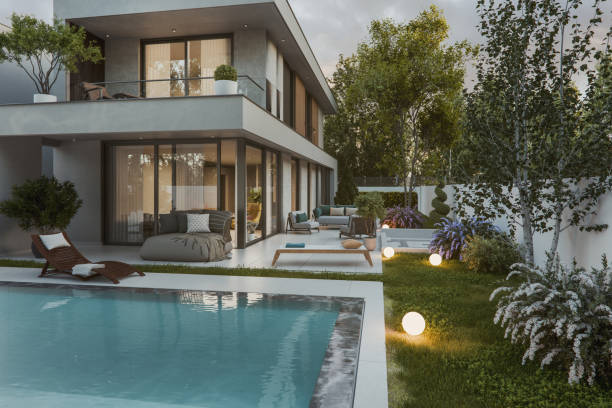 istock Modern house with garden and pool at sunset 2165598615